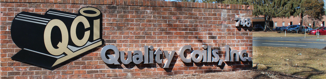 Welcome sign of business on brick wall.