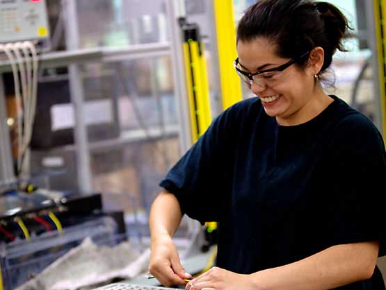Female quality coils operator testing coils.